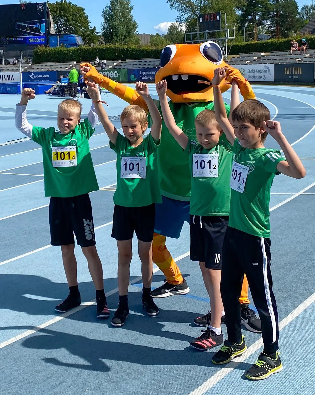 Children celebrating movement with the Geego mascot at a Finnish athletics event
